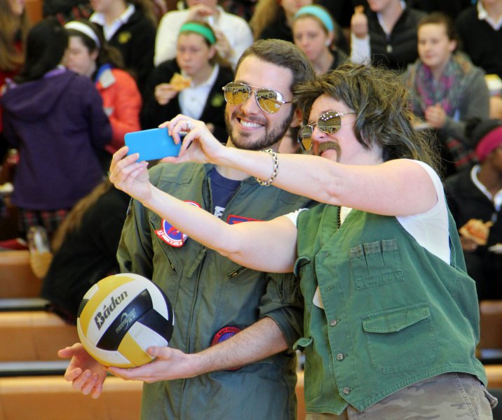 Theology teacher Michael Sanem, left takes a selfie with English teacher Carrie Jaquin before the start of the volleyball game Nov. 12. The M&A team theme was "'Top Gun." photo by Anna Leach 