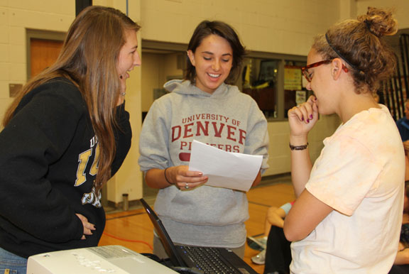 Seniors Liz Wiens, left, Melissa Lane and Lucy Edmonds prepare for a presentation about teen depression and suicide April 27. The three girls organized the "Out of the Darkness" event. Photo by Allison Fitts