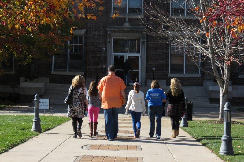 Senior Katherine Viviano, far right, leads her tour group across the quad Nov. 10 at the open house. Although tours were not scheduled to walk through the M&A Building, Viviano let her group tour M&A.