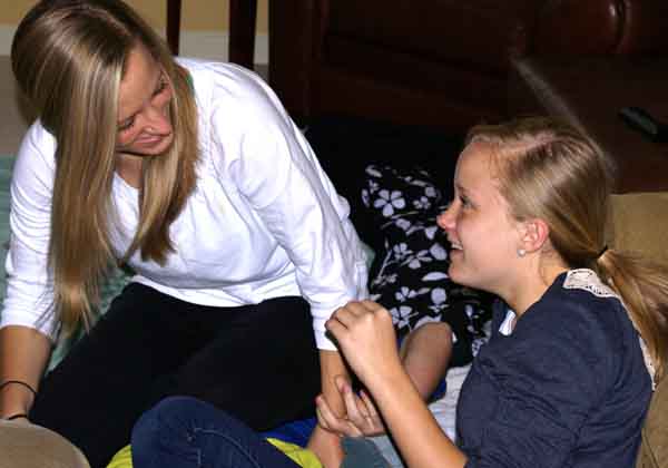 Stephanie Lankford, left, and Megan Lankford laughing and having a good time in the living room while watching TV. Sitting around the house with one another always brings them closer. (Hannah Krull)