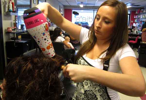 Mrs. Angela Tatum, left, and Mrs. Diana Ohmes at Blondie's Salon in Independence. Tatum was blow drying Ohmes's hair after coloring and cutting it. (Adrianna Ohmes)