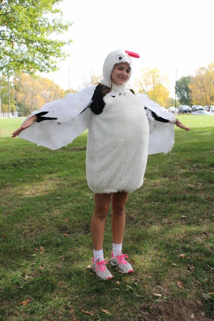 Junior Elaine Kerr spreads her wings in her homemade chicken costume.