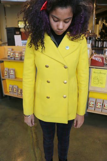 Coats are here to keep us warm, right? Well, they also can be the star of an outfit. This yellow coat is so gorgeous, and by wearing all black, she really makes it stand out.